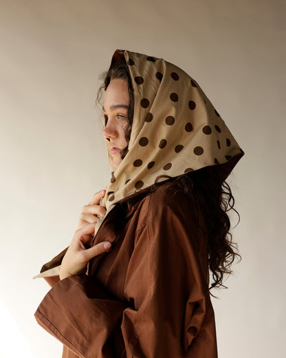 Brown oversized trench coat with detachable beige polka dot hood scarf