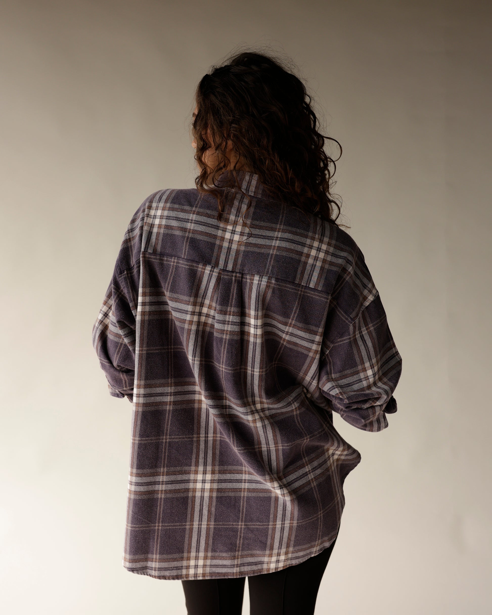 Navy plaid flannel oversized button-up shirt, back view, worn with black pants