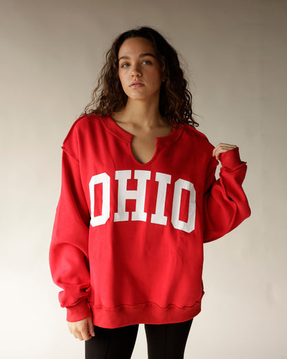 Red oversized Ohio sweatshirt with split neck and white block letters on woman