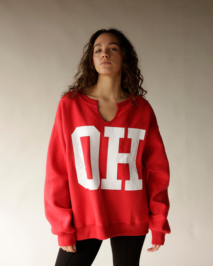 Oversized red split-neck sweatshirt with large white OH letters on front