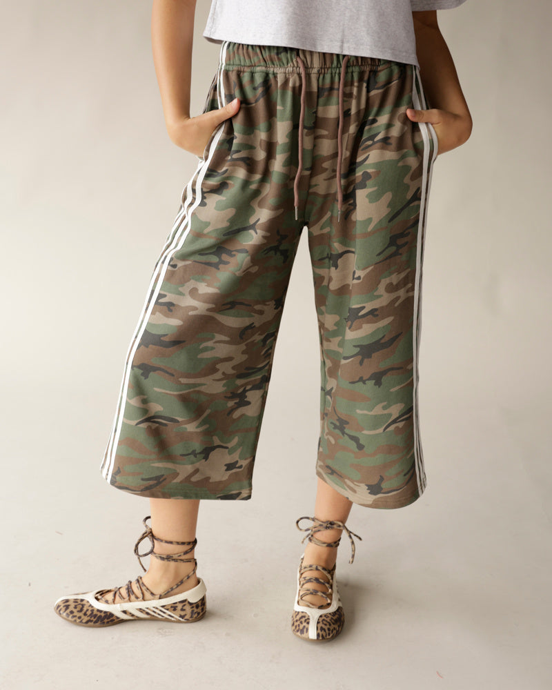 Wide-leg camouflage capri pants with white side stripes and elastic drawstring waist