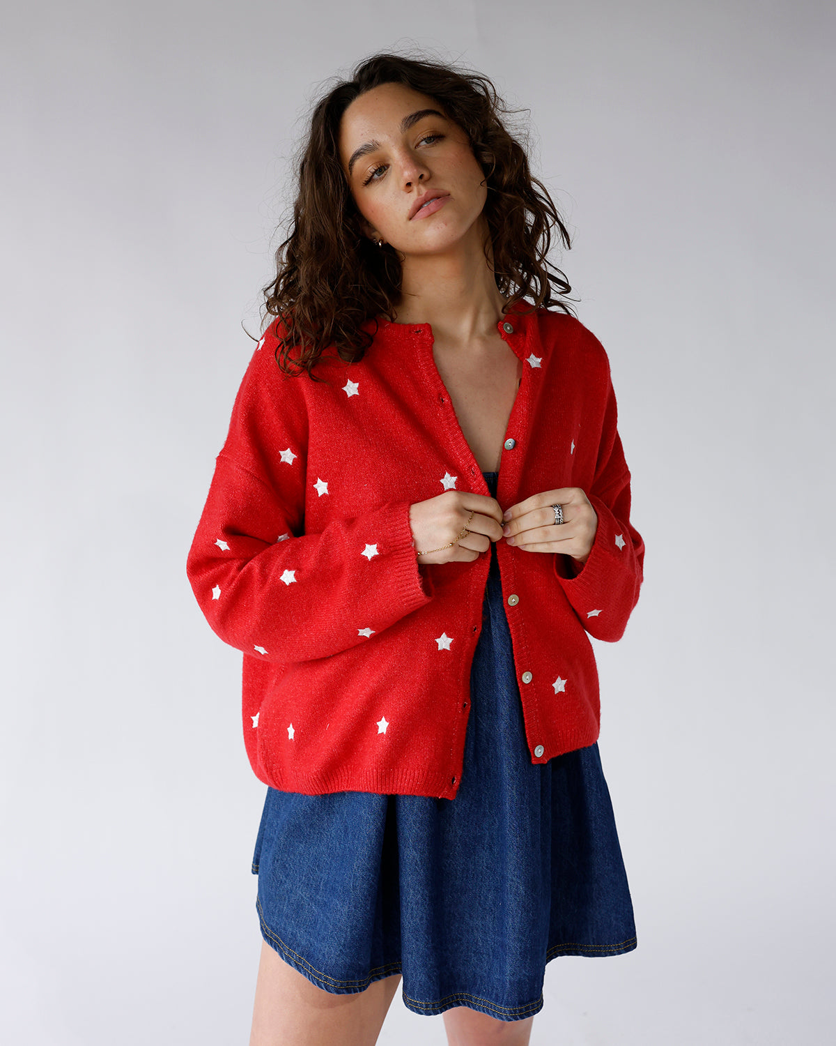 red long sleeve button front cardigan with all over white embroidered stars