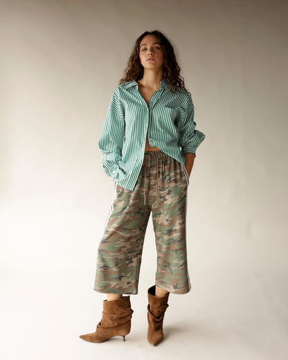 Green and white striped oversized button-up shirt with open collar and cropped hem