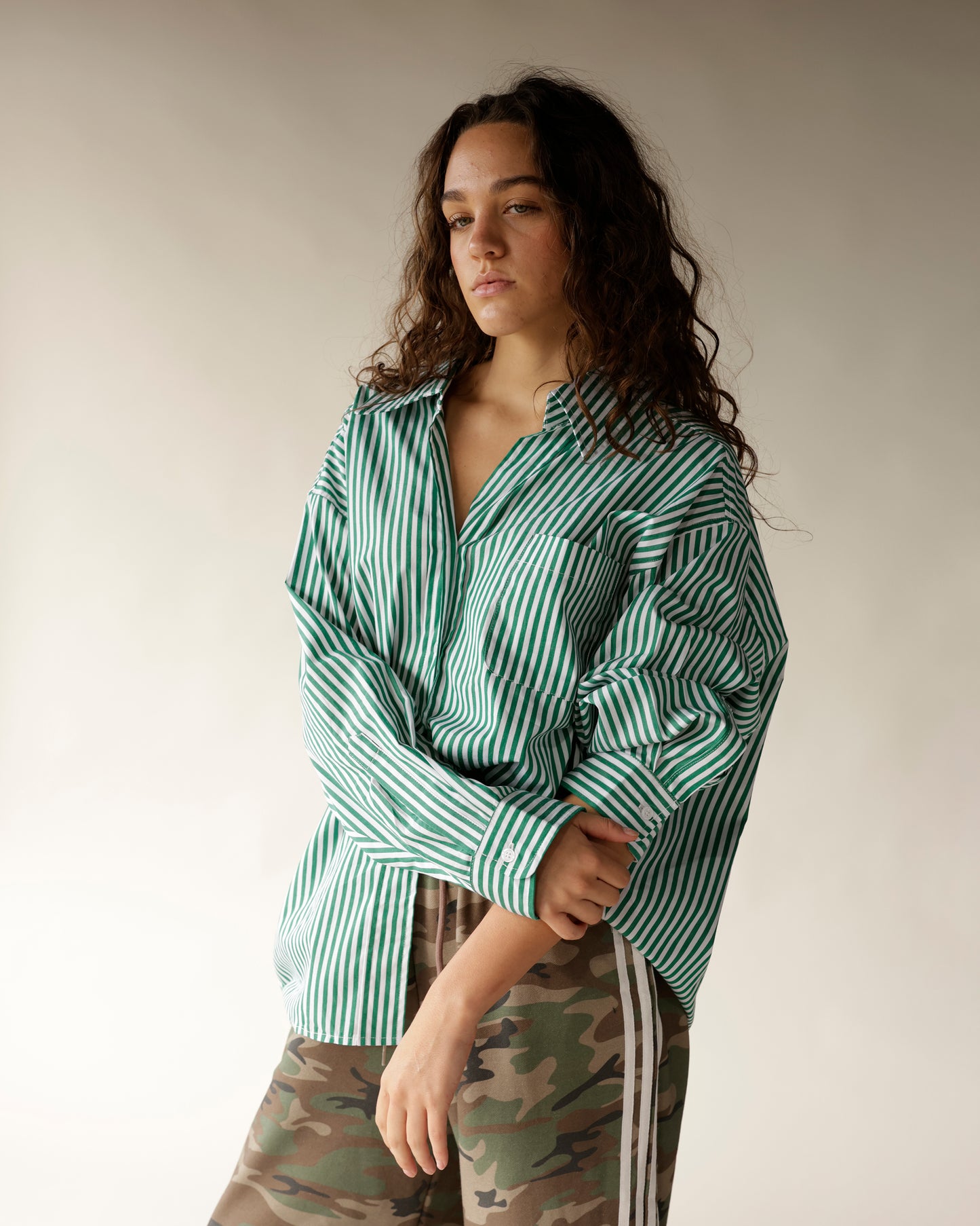 Oversized green and white striped button-up shirt with chest pocket and open collar