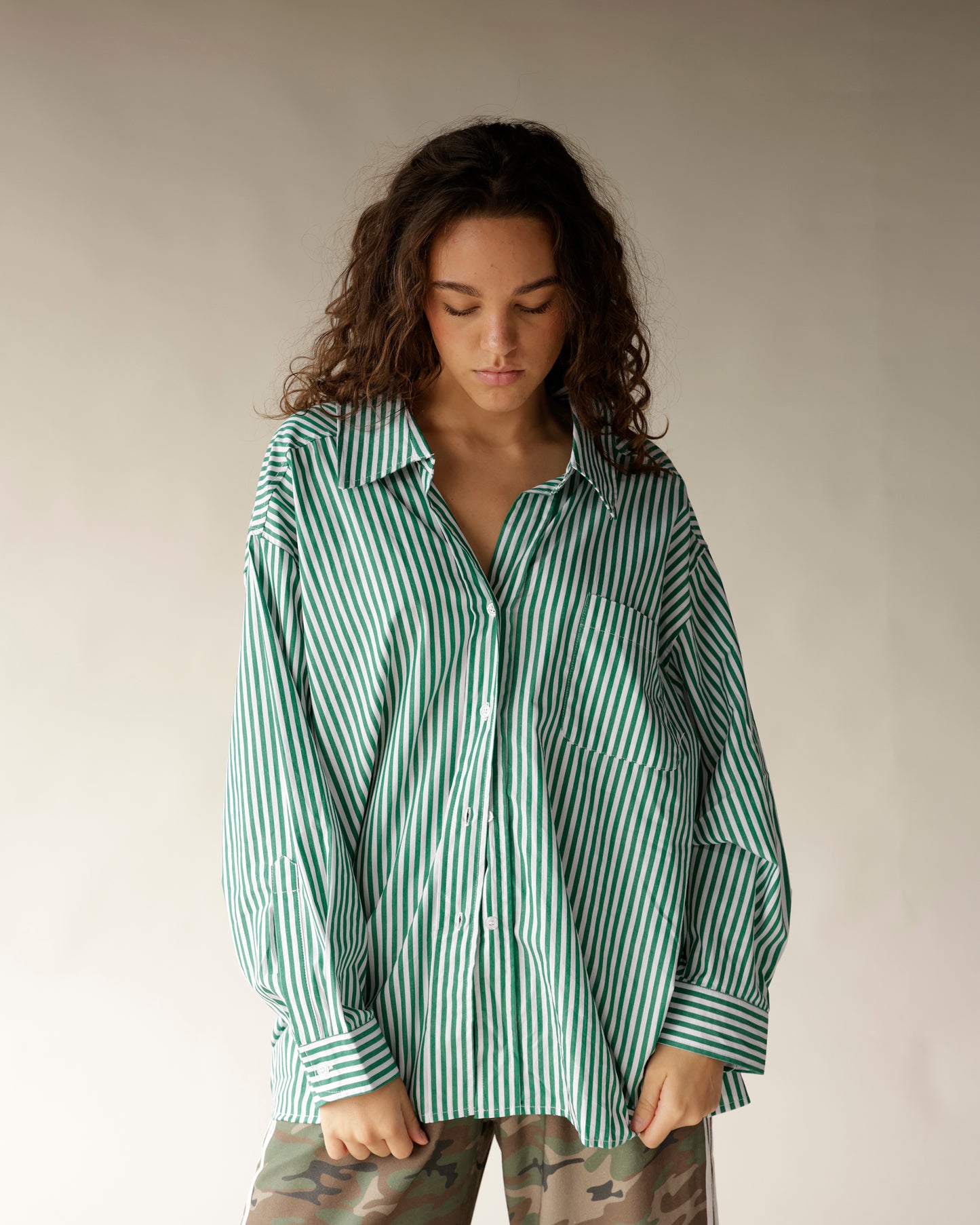 Oversized green and white striped button-up shirt with chest pocket and long sleeves