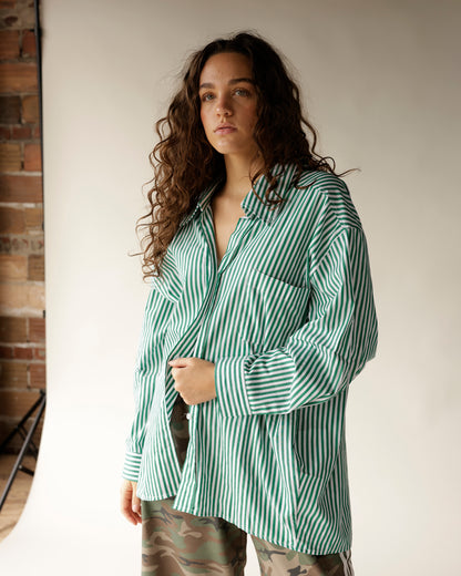 Oversized green and white striped button-up shirt with long sleeves and chest pocket