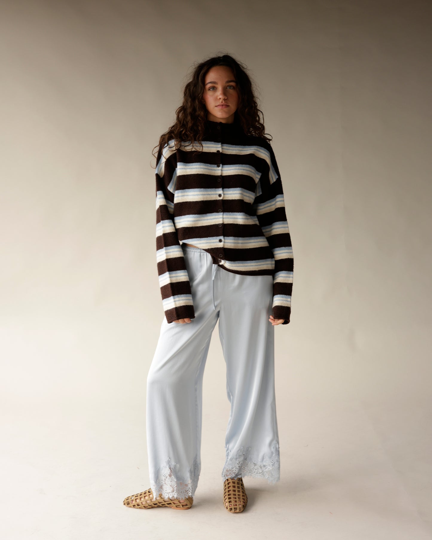 Brown striped mock neck button-up cardigan with blue and cream horizontal stripes