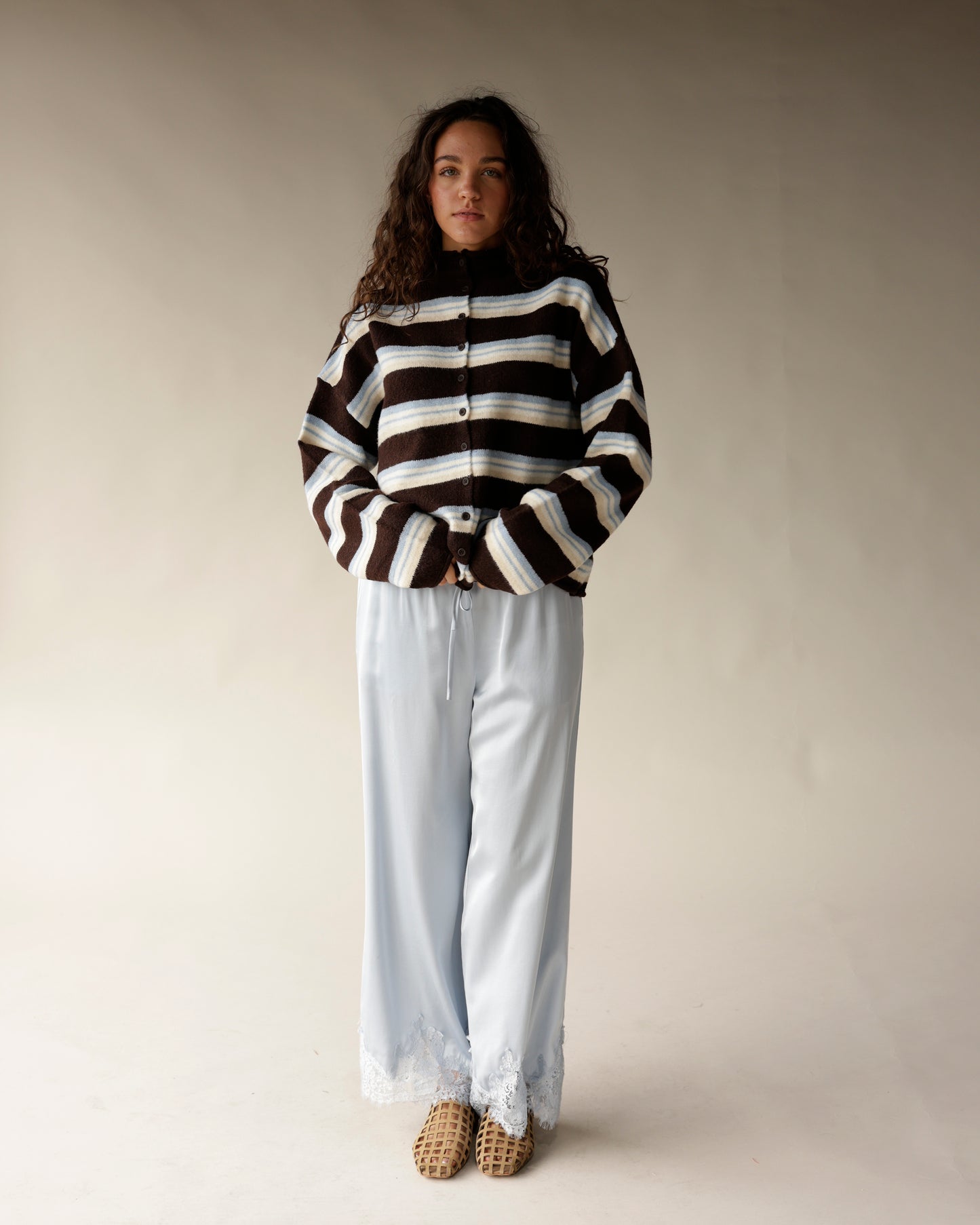 Brown striped mock neck cardigan with blue and cream stripes, button front closure