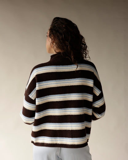 Brown striped mock neck cardigan with cream and blue stripes, back view