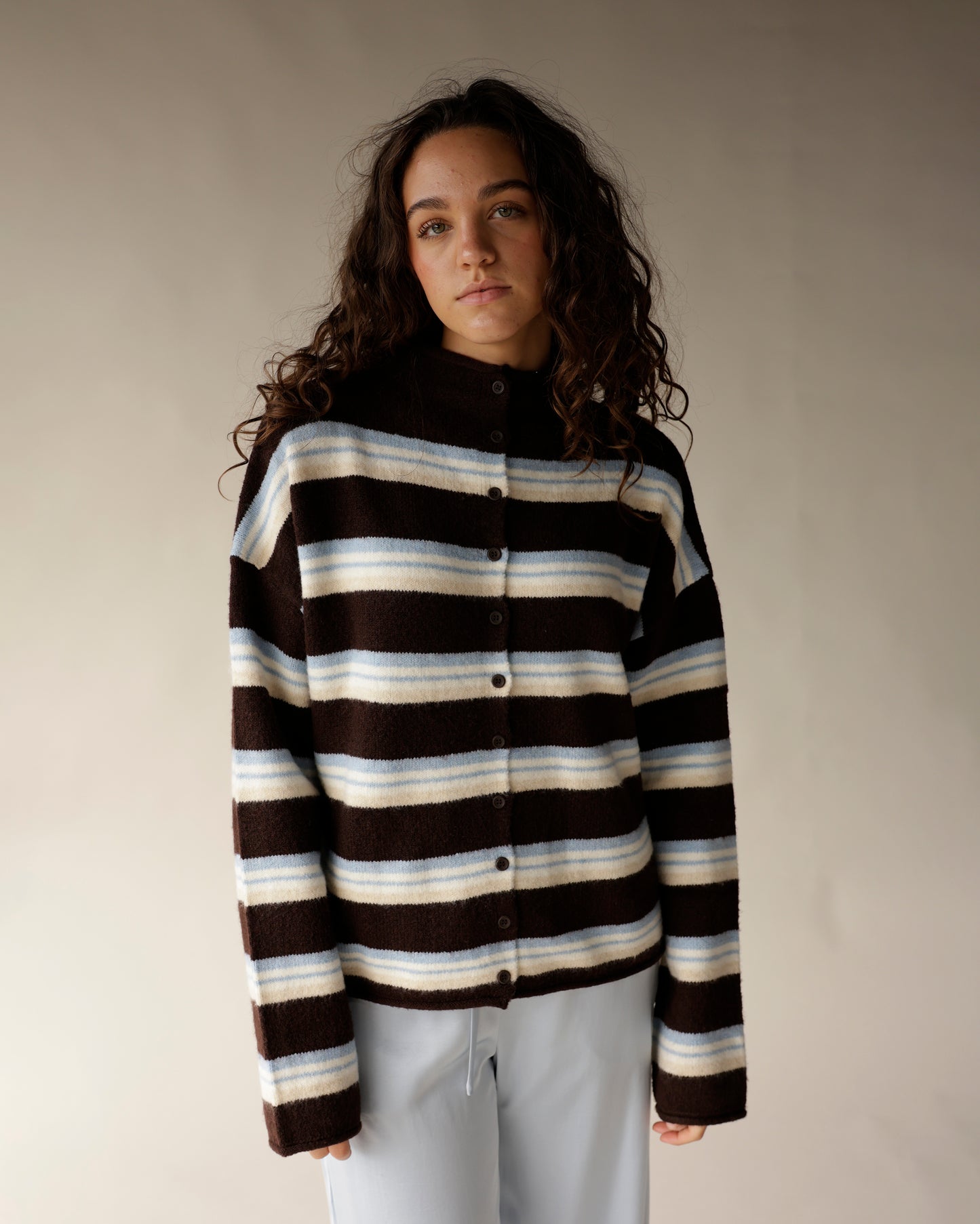 Brown striped mock neck cardigan with cream and blue stripes, button front