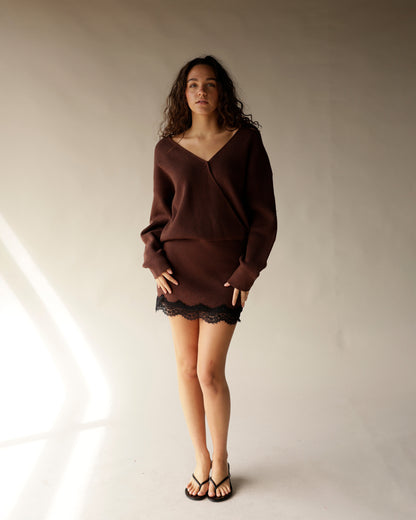 Brown ribbed knit V-neck sweater mini dress with black lace hem and flip flops