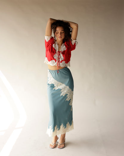 Dusty blue satin midi skirt with ivory lace trim and diagonal lace appliqué detail