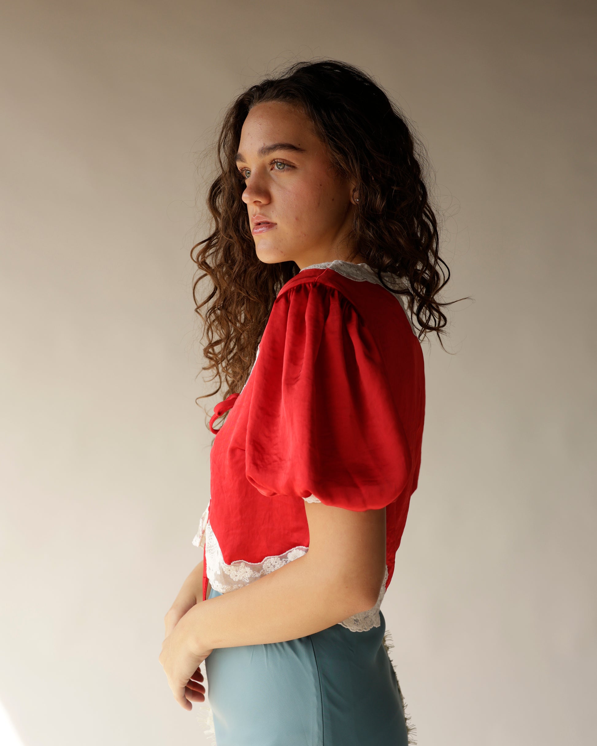 Red satin puff sleeve crop top with white lace trim collar and hem
