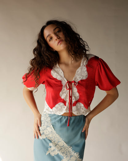 Red satin crop top with white lace trim and tie-front detail, puff sleeves