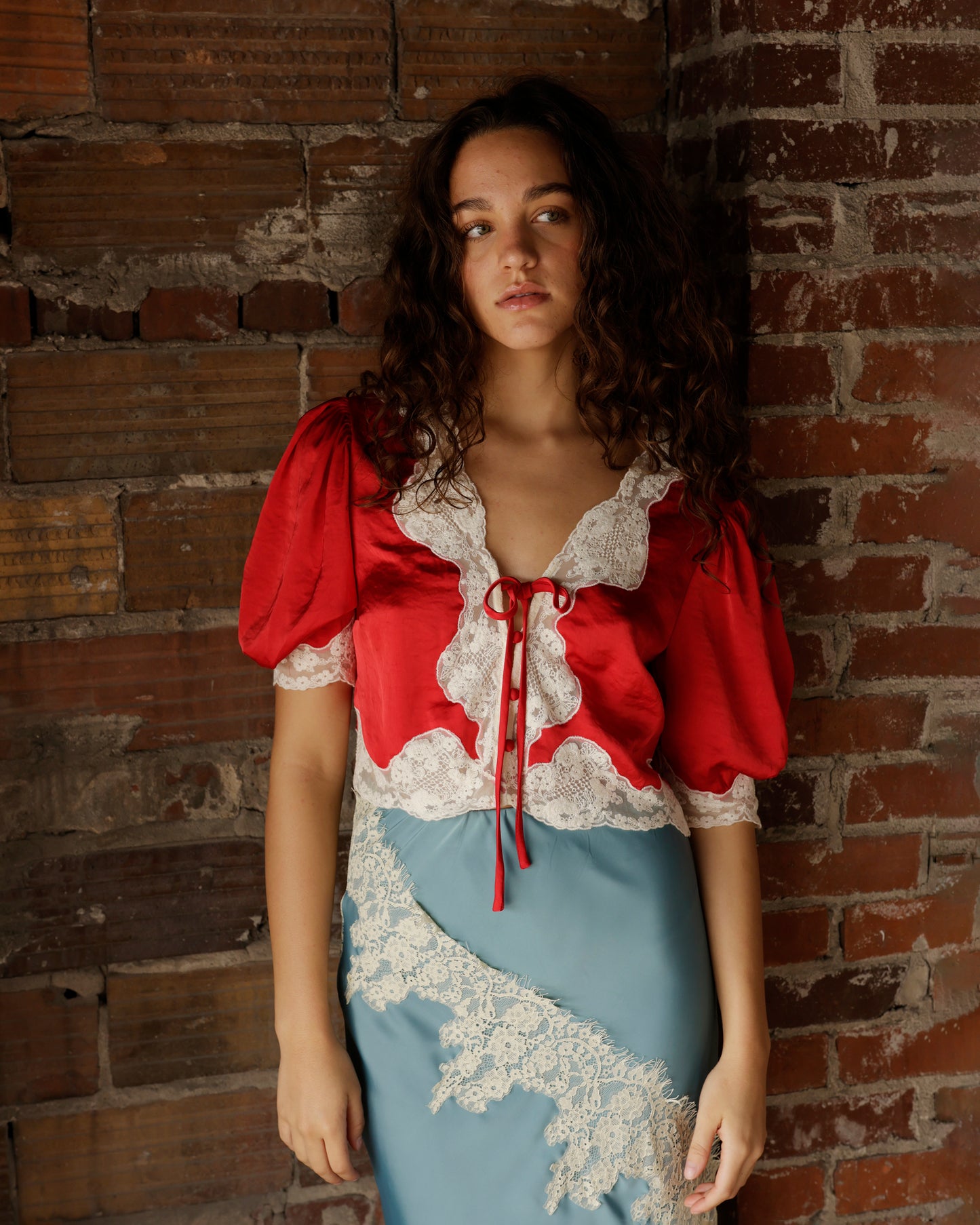 Hendricks red satin crop top with white lace trim and puff sleeves