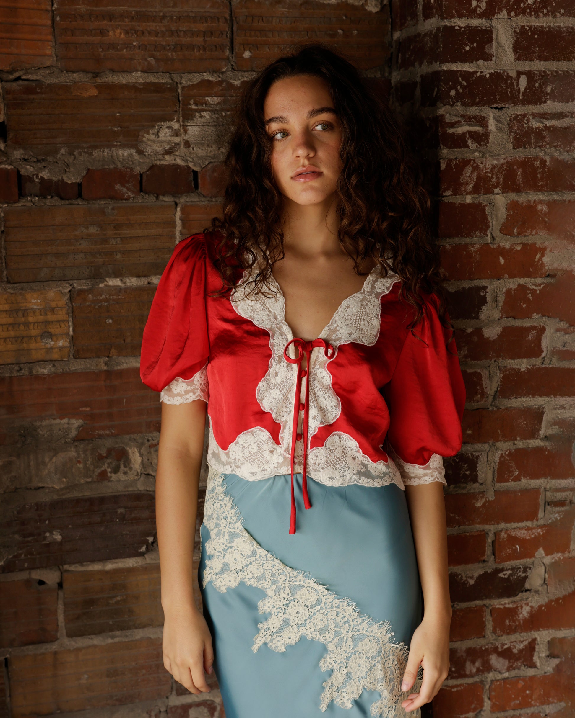 Hendricks red satin crop top with white lace trim and puff sleeves