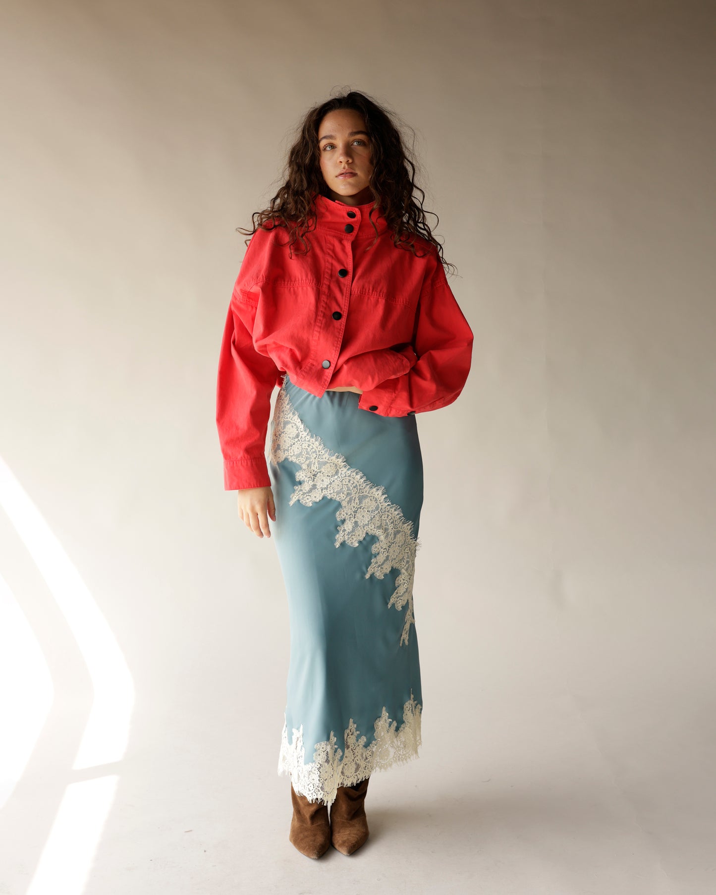 Dusty blue satin midi skirt with diagonal white lace trim detailing
