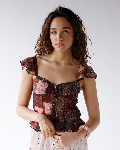 patchwork patterned button front top with ruffle sleeves and peplum hem