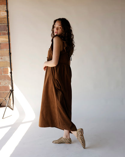 Brown corduroy midi dress with ruffle straps, tiered skirt, and side pockets