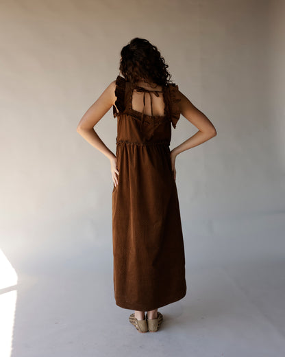 Brown corduroy midi dress with ruffle straps, open tie back, and side pockets
