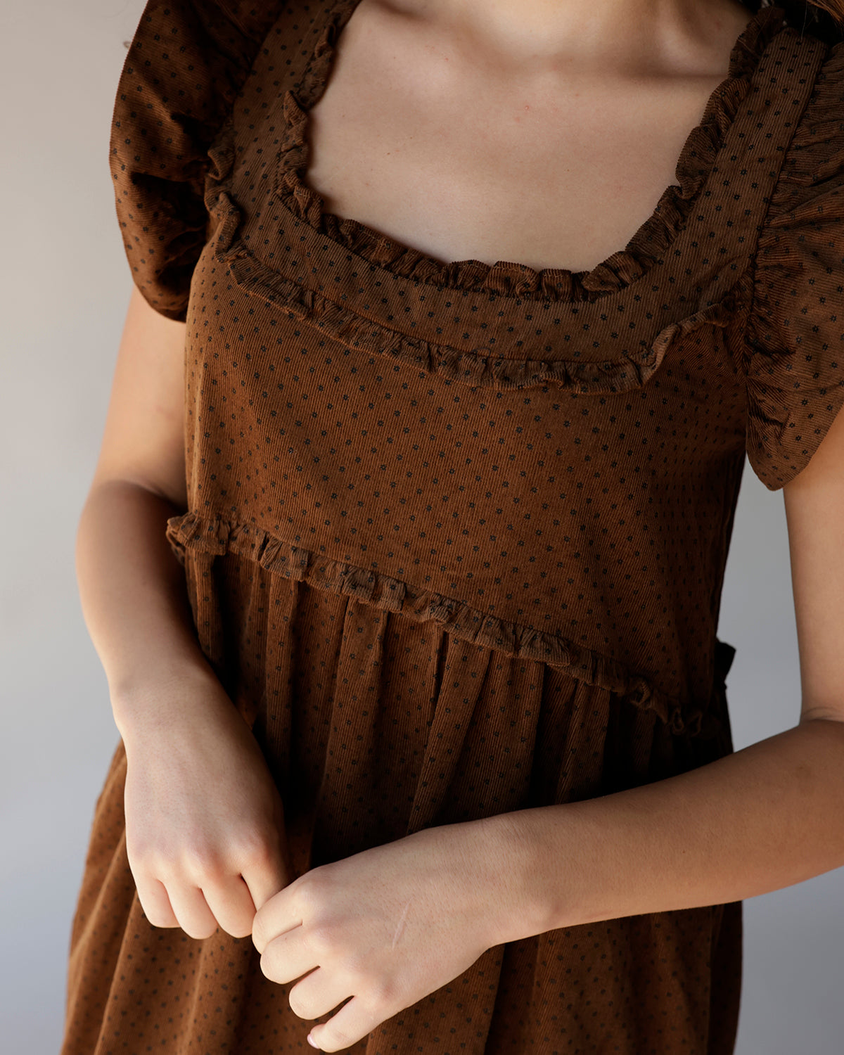 Brown polka dot corduroy midi dress with ruffled square neckline and puff sleeves