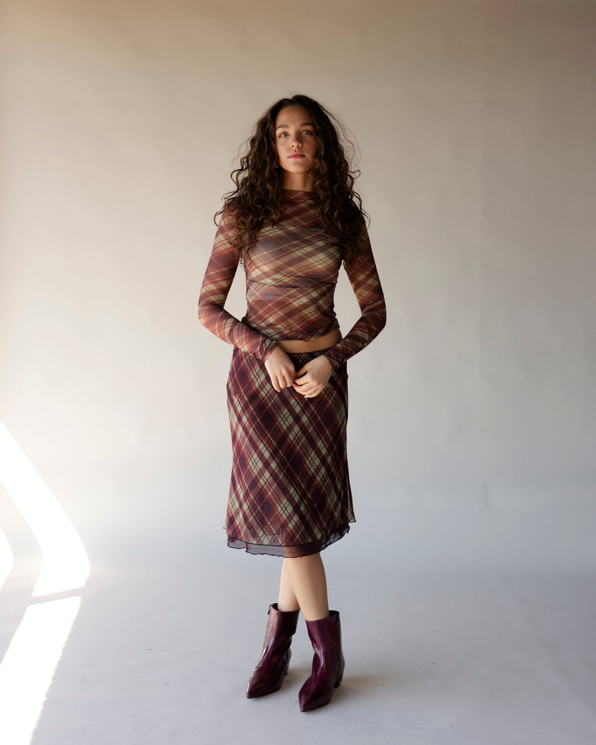 Brown plaid mesh long sleeve crop top with semi-sheer fabric and fitted silhouette