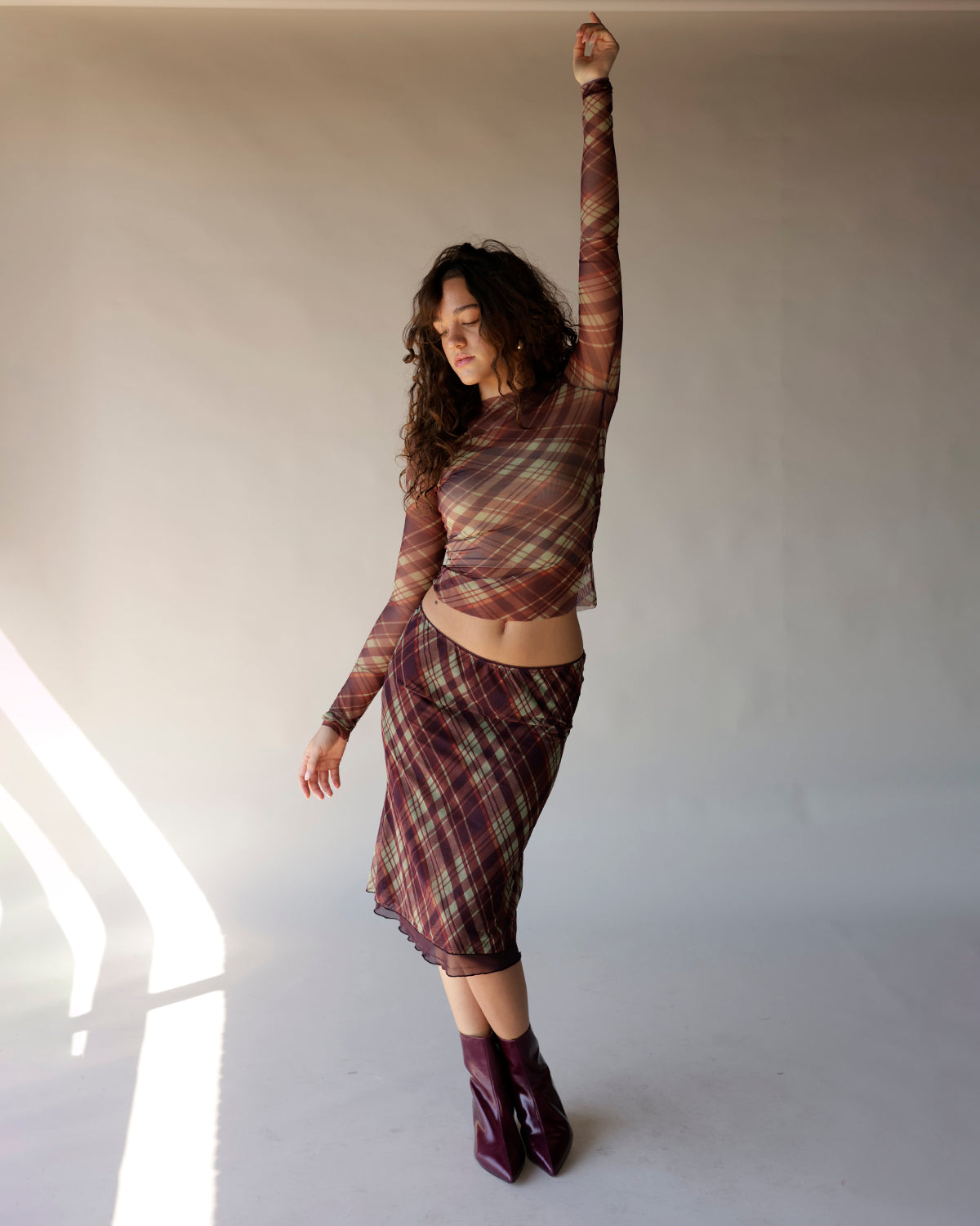 Burgundy plaid mesh long sleeve crop top with sheer fabric and fitted silhouette