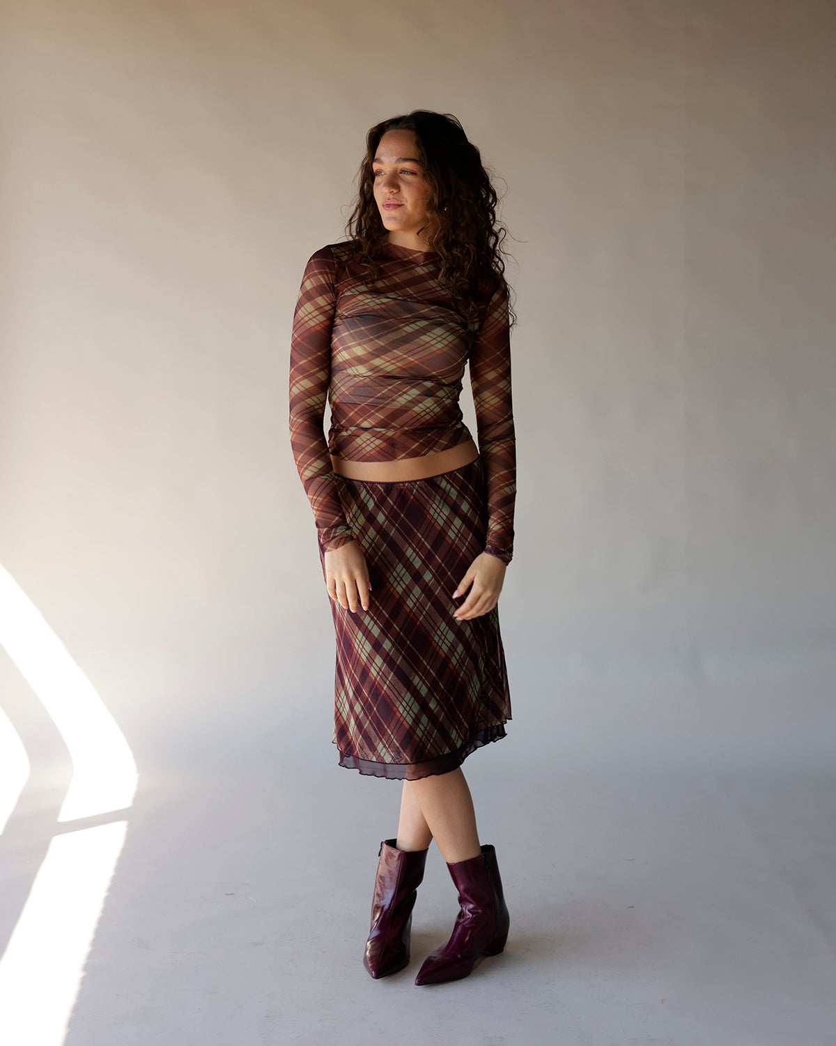 Brown plaid mesh long sleeve crop top with sheer fabric and fitted silhouette