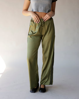 Olive green satin wide-leg track pants with black side stripes and drawstring waist