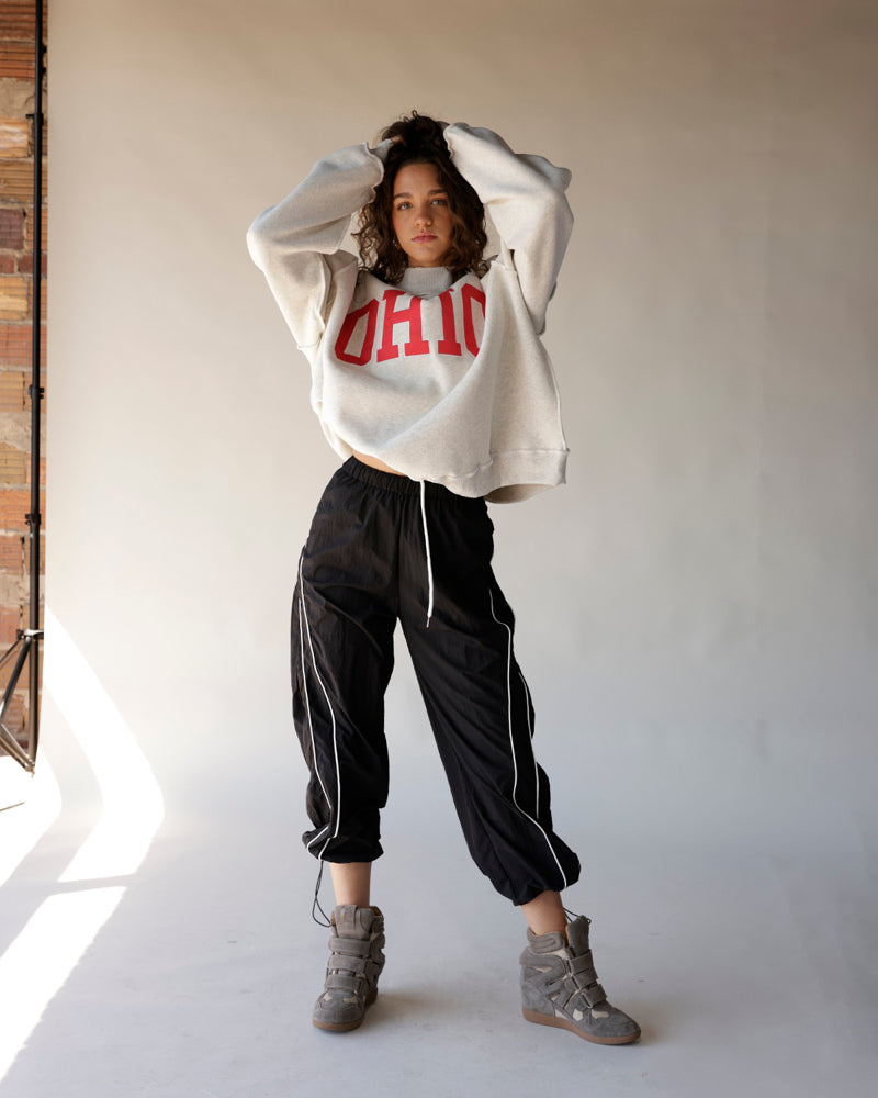 Gray Ohio mock neck crop sweatshirt with red lettering, worn with black track pants