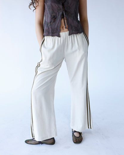 cream wide leg track pants with olive green track stripes