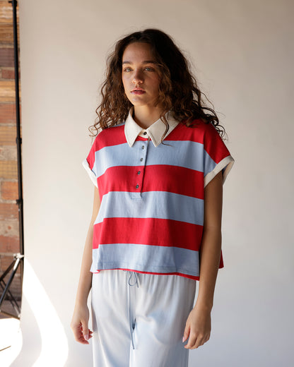 Red and blue wide stripe sleeveless crop polo top with white collar and buttons
