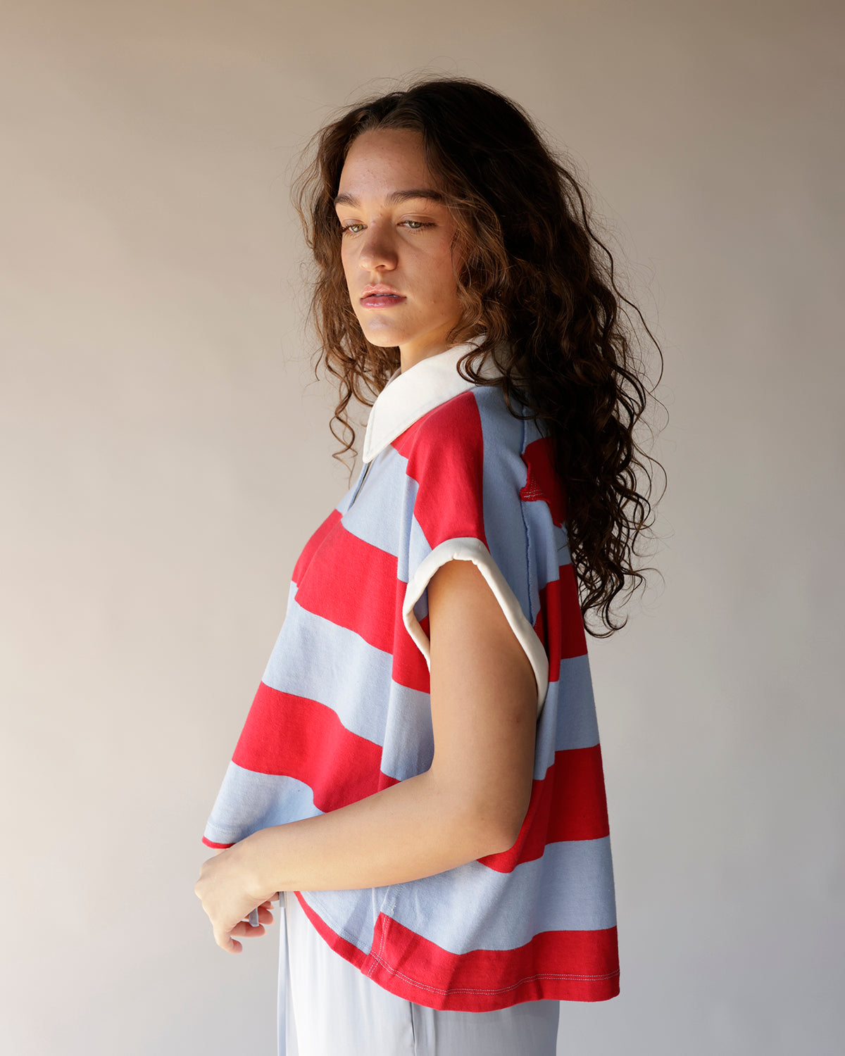 Red and light blue wide stripe cropped polo top with white collar and short sleeves