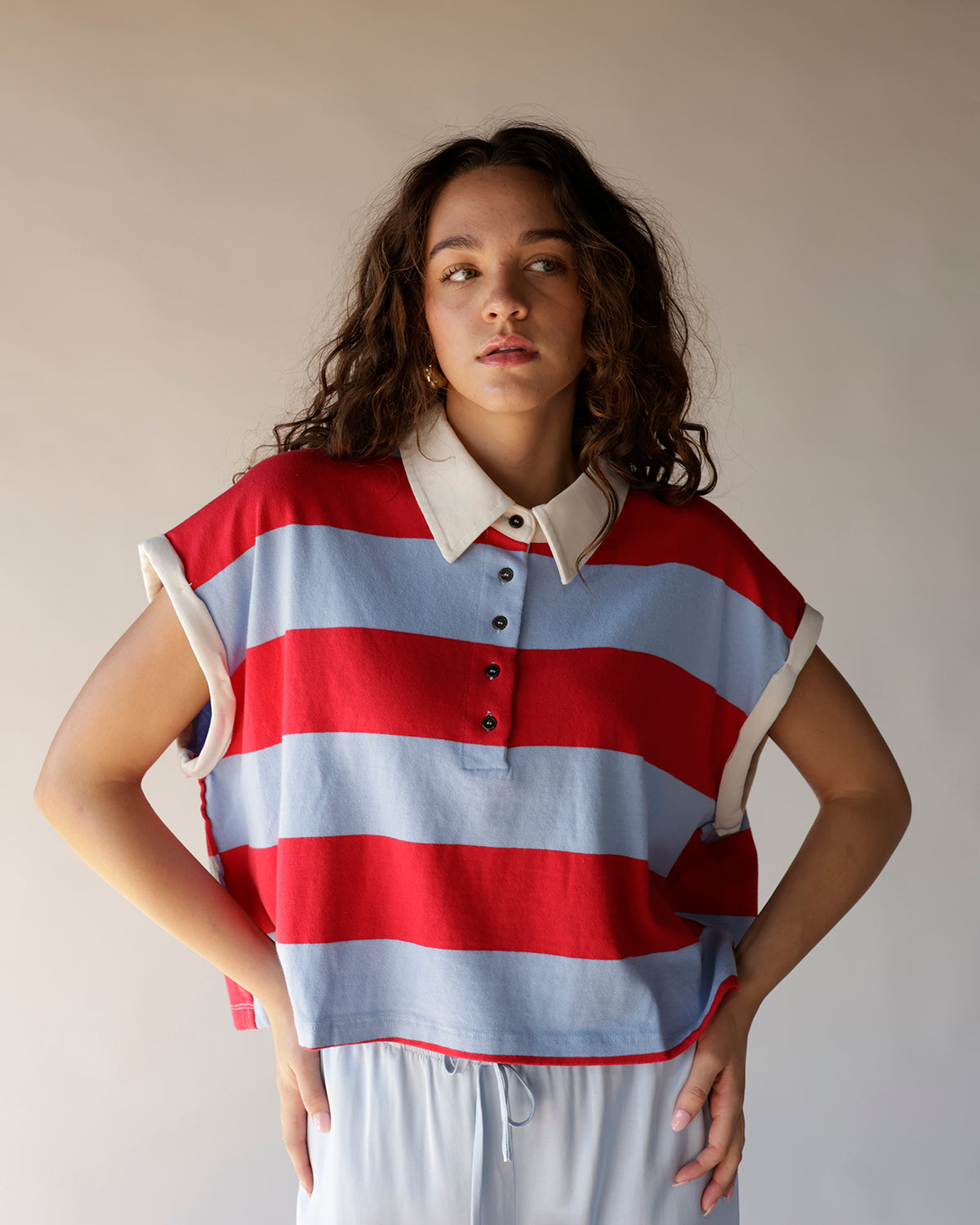 Red and blue stripe sleeveless crop polo top with cream collar and buttons