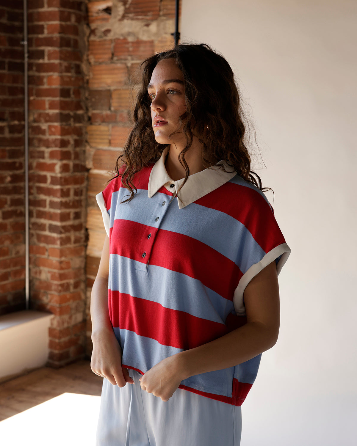Red and blue striped sleeveless polo crop top with white collar and buttons