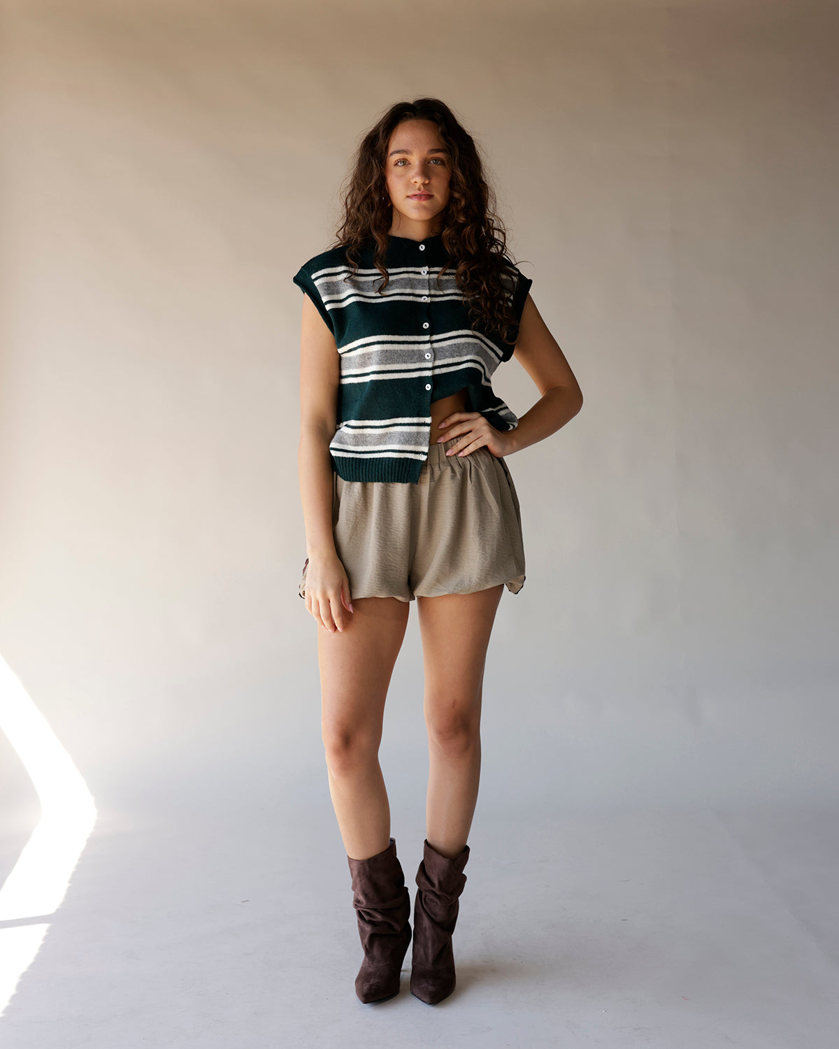 Dark green striped sleeveless knit cardigan vest with button front and ribbed hem