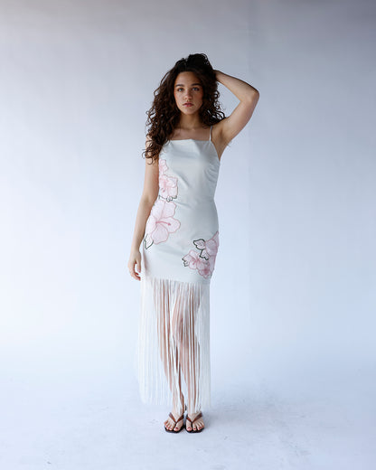 white maxi dress with floral print and fringe hem