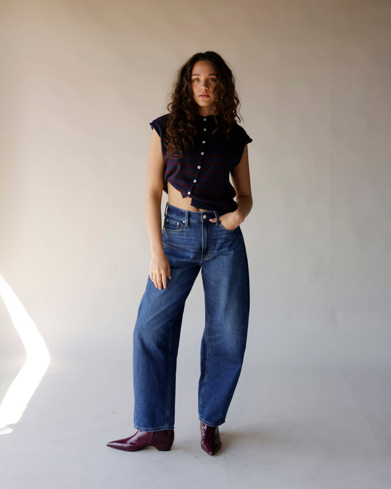Dark navy striped sleeveless cropped sweater with button front, worn with wide-leg jeans