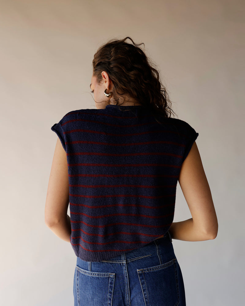 Navy blue striped knit sweater vest with red stripes, back view