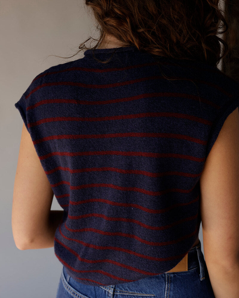 Navy blue striped sleeveless sweater top with dark red horizontal stripes, back view