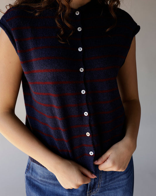 Navy blue striped sleeveless sweater vest with red stripes and white buttons