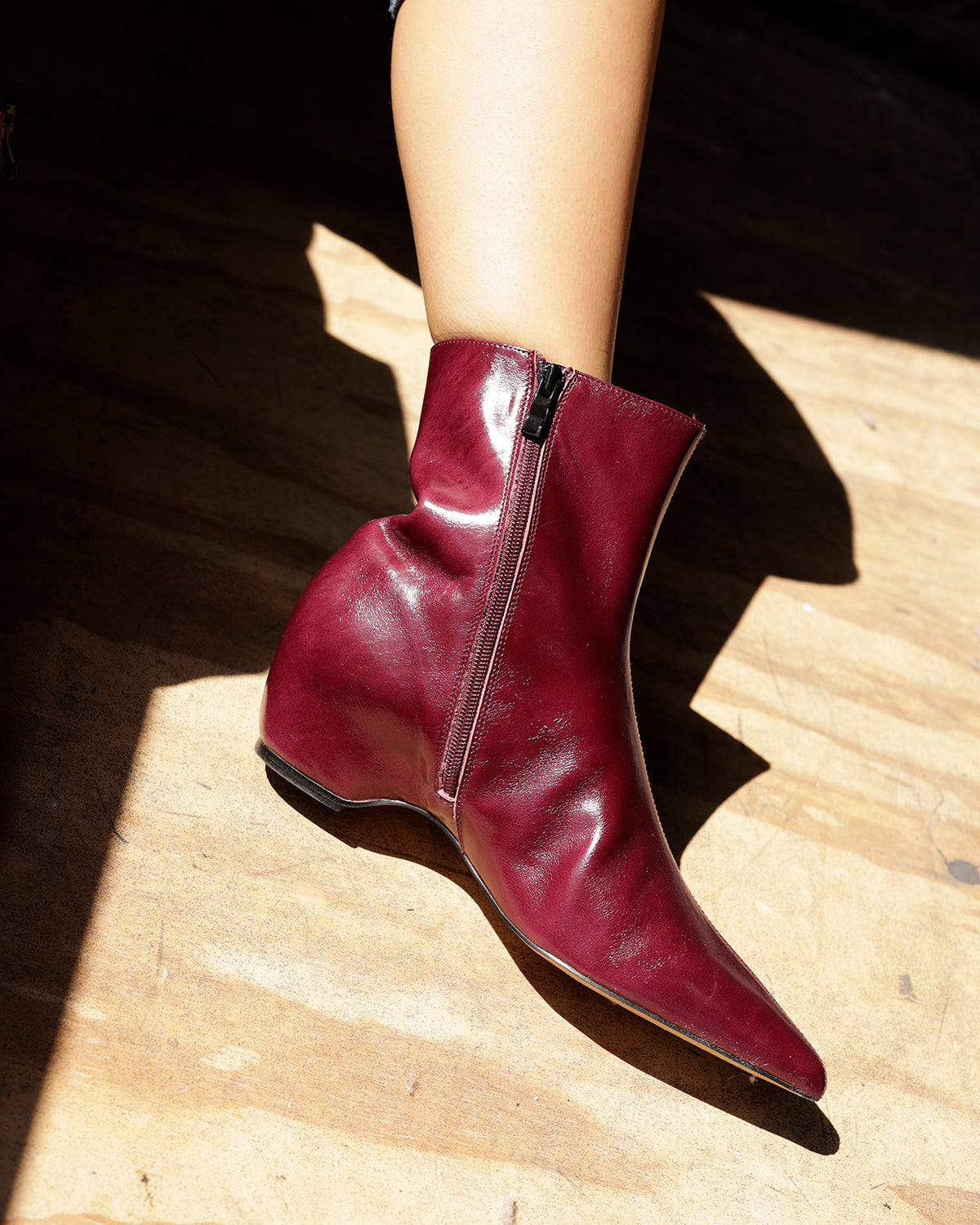 Steve Madden maroon leather ankle bootie with side zipper and pointed toe