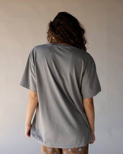 Oversized gray graphic tee shown from back, relaxed fit, short sleeves