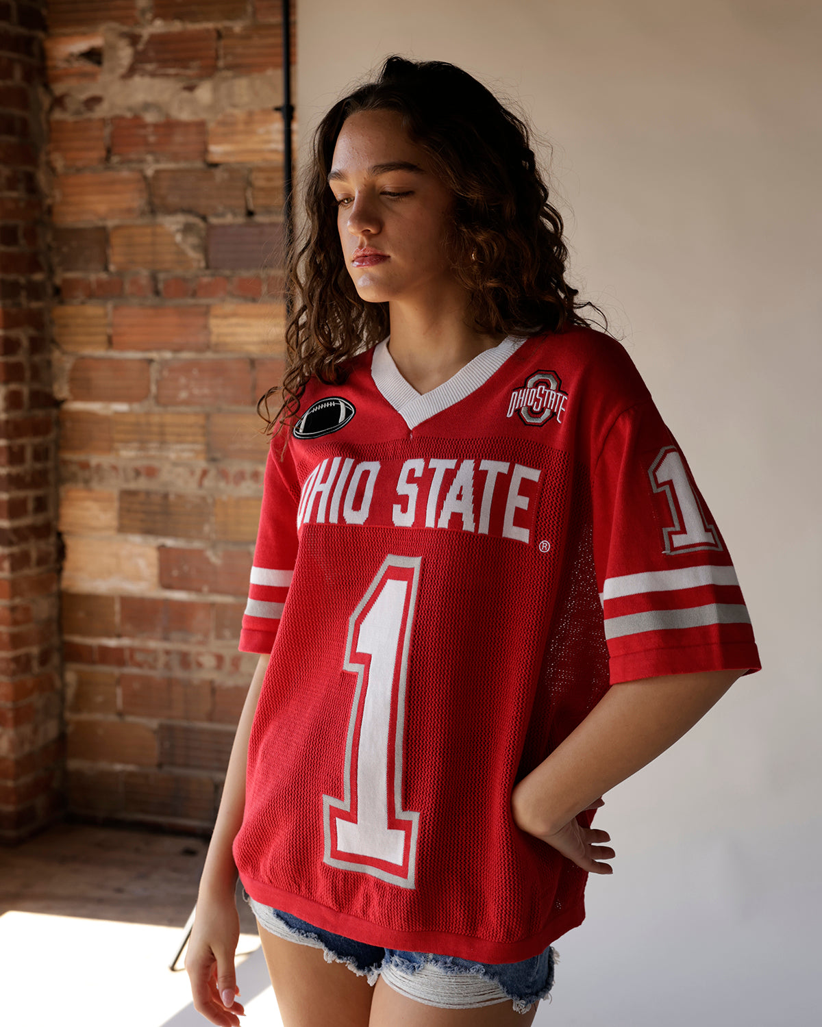 Women's red Ohio State #1 football jersey with white stripes and mesh fabric