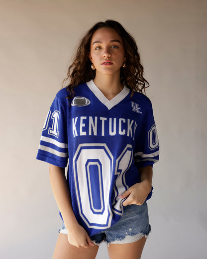 Women's oversized blue Kentucky Wildcats football jersey with number 01 and denim shorts