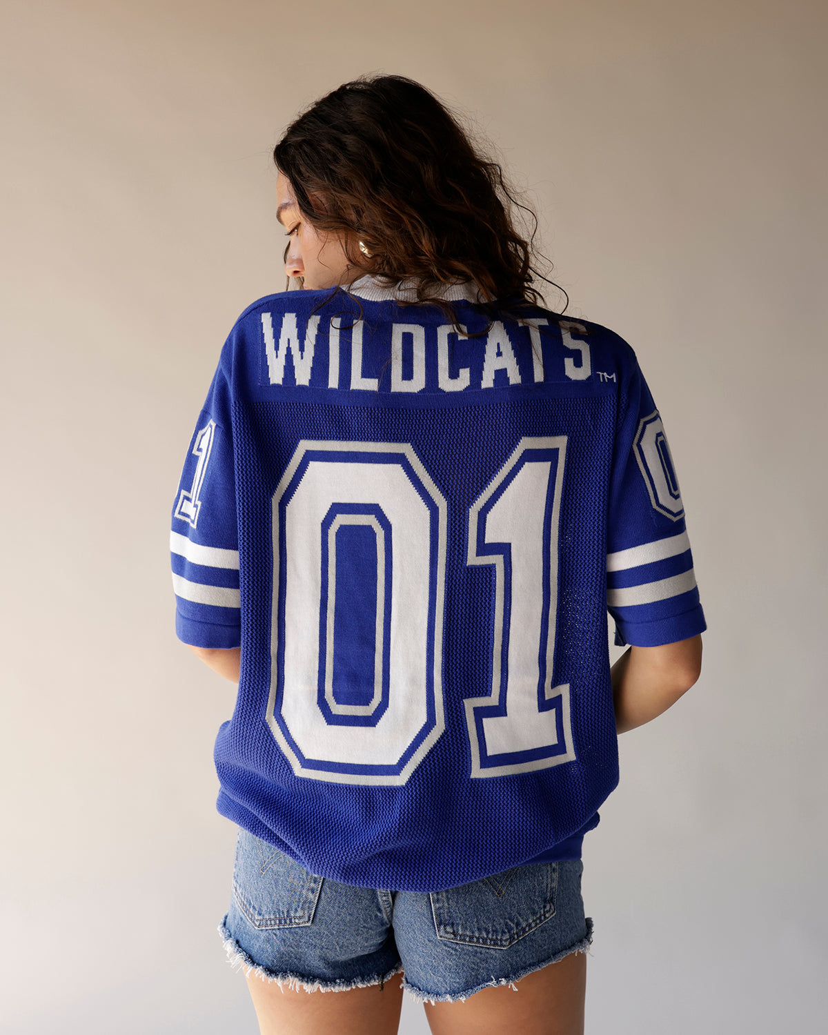Women's blue Kentucky Wildcats knit football jersey number 01 with denim shorts