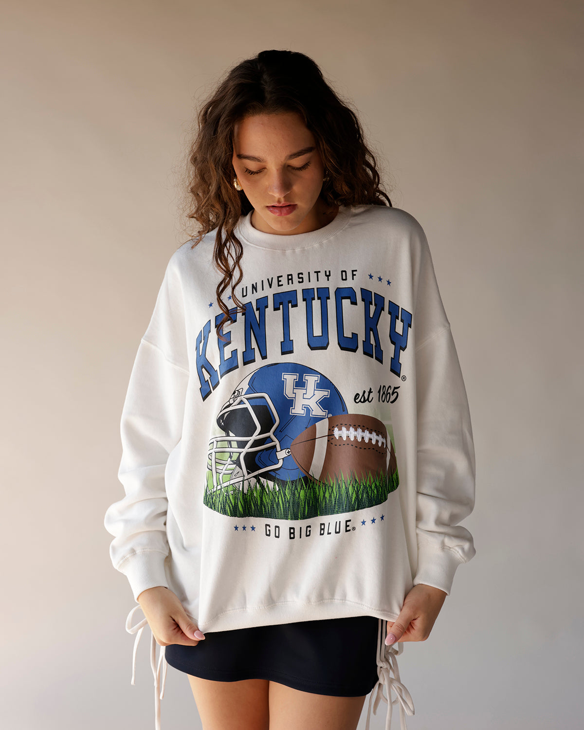 White oversized University of Kentucky football graphic crewneck sweatshirt with lace-up hem