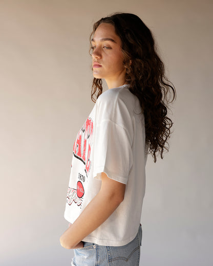 White oversized graphic tee with red retro Brutus print, worn by model with jeans