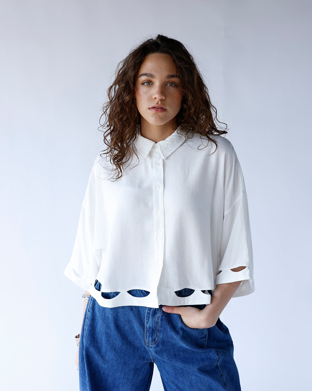 white button front collared blouse with cut-out details and quarter sleeves