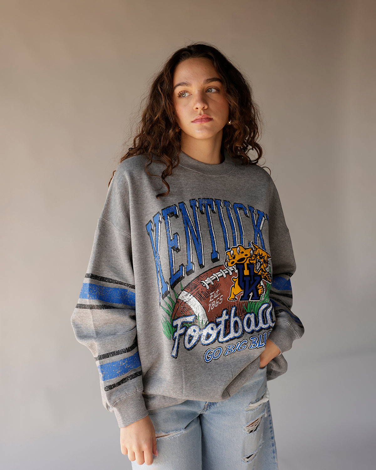 Gray Kentucky Football throwback crewneck sweatshirt with distressed graphic and stripe sleeves
